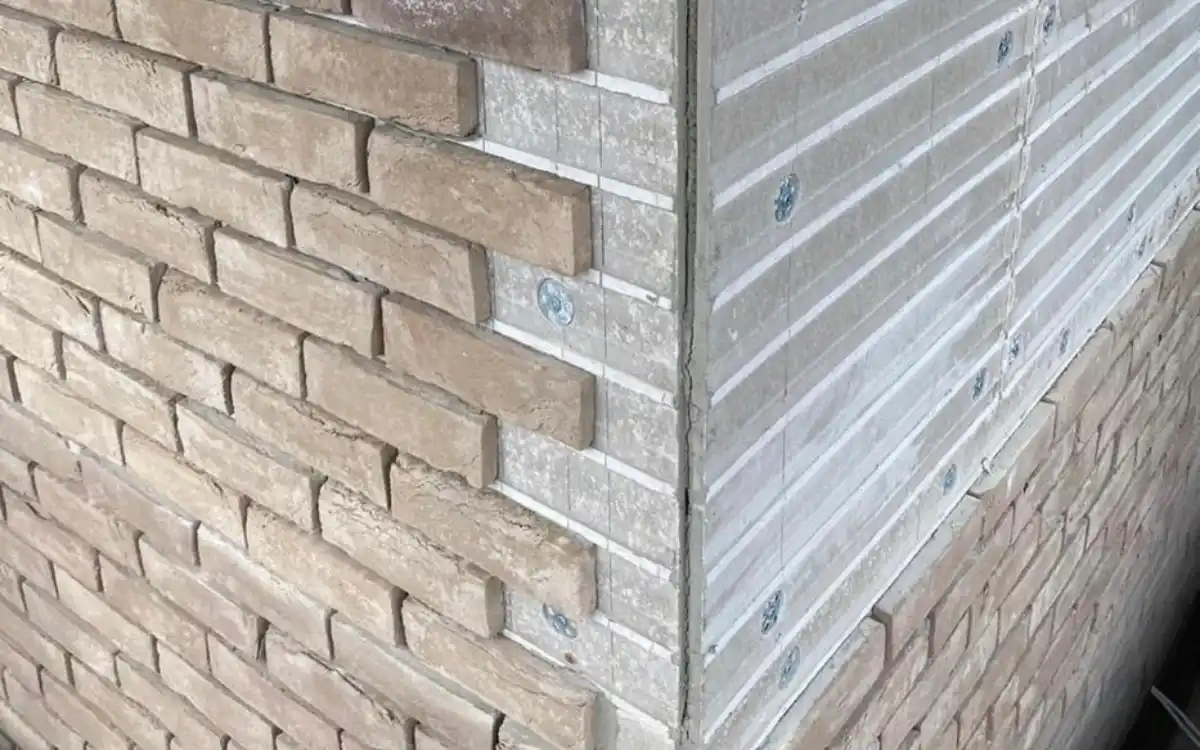 Brick slip cladding being applied to a Superstrux extension